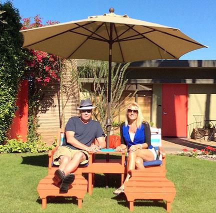 two people sitting under and umbrella