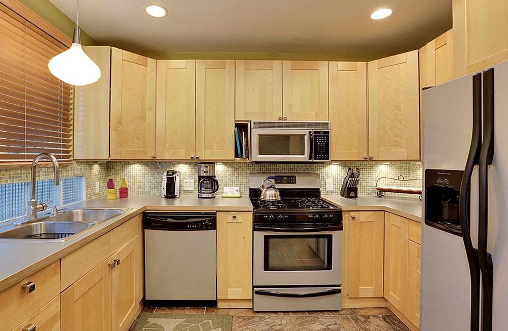 In room full kitchen, with microwave, dishwasher, oven, and fridge.